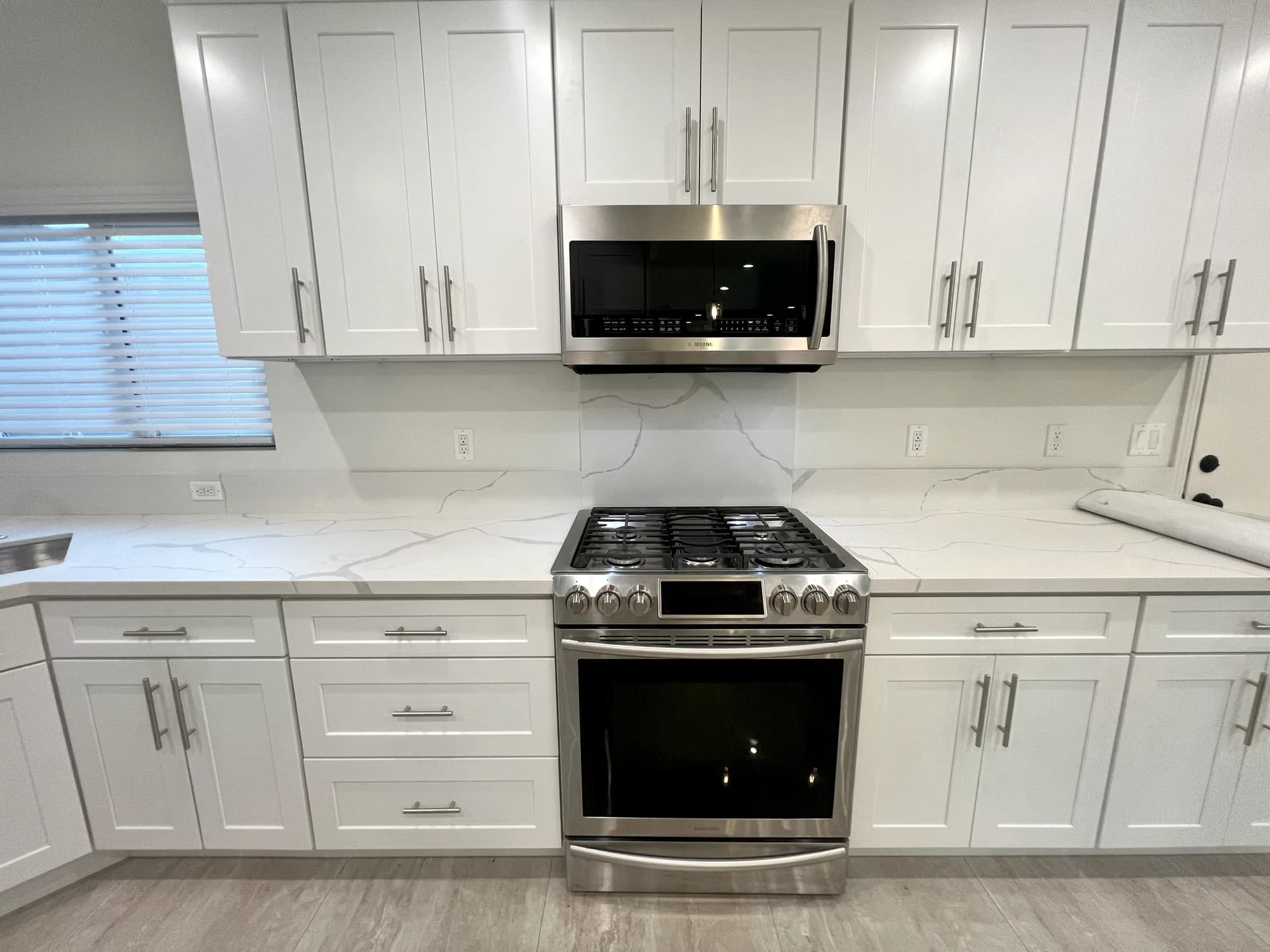 Shaker kitchen with slab backsplash